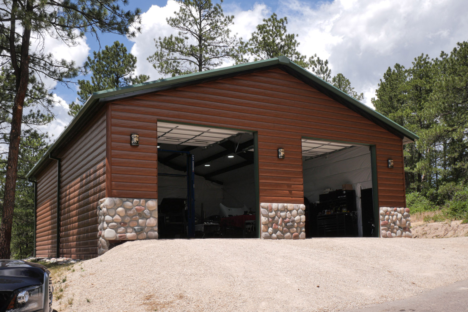 A steel Great Western Buildings metal shop kit in the mountains of Larkspur Colorado with log cabin style siding front 3/4