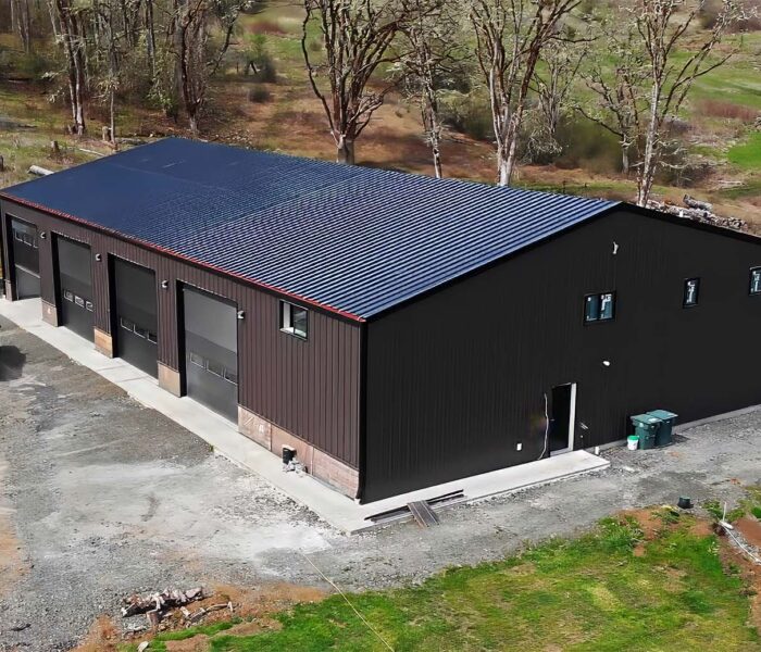 Oregon Contractor steel metal building on property among trees and grass